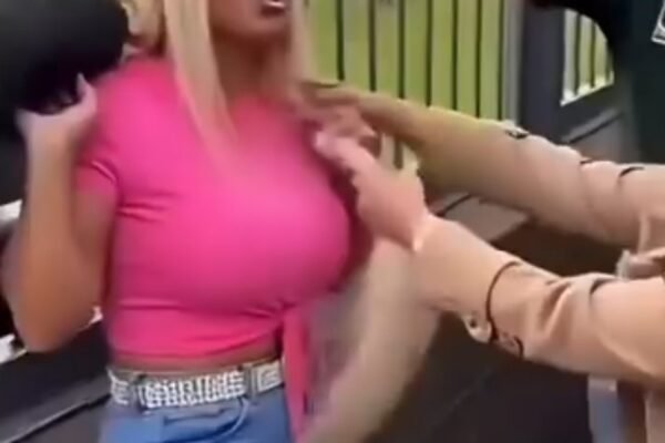 Woman in a bright pink top in a heated public confrontation caught on camera