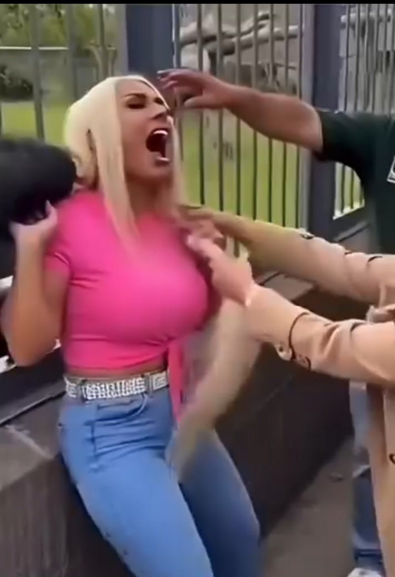 Woman in a bright pink top in a heated public confrontation caught on camera